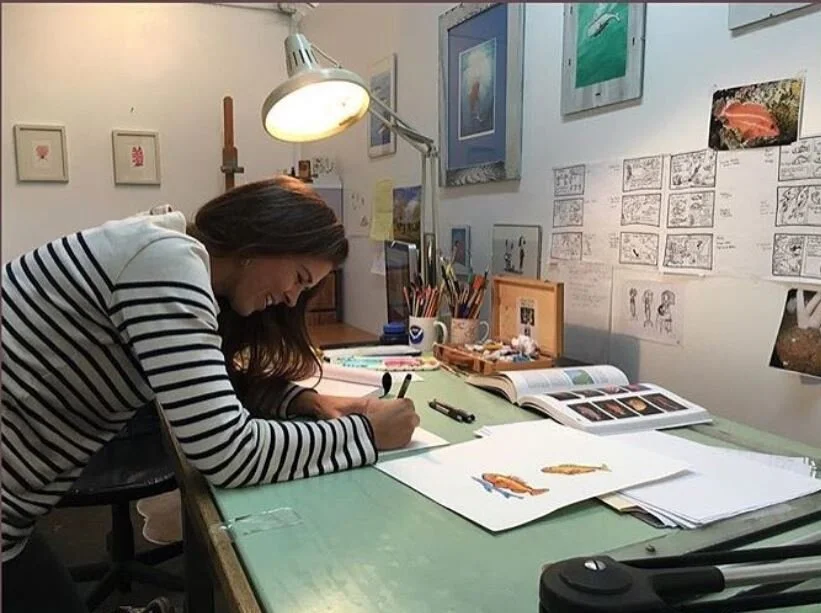 Claudia Makeyev painting at her desk